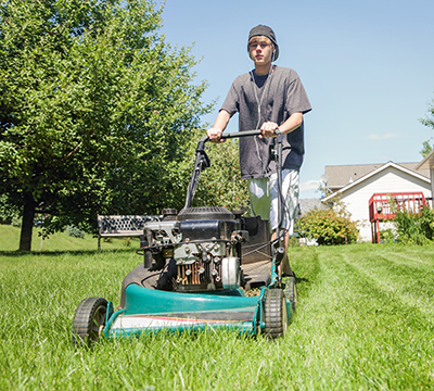Teen Mowing Lawn
